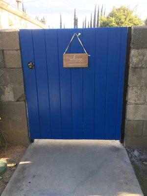 Red wood dog ear painted blue(owner request) on small pedestrian gate