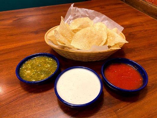 Chips with green and red salsas, and ranch.