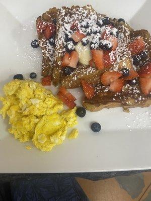 French toast with berries and side of eggs