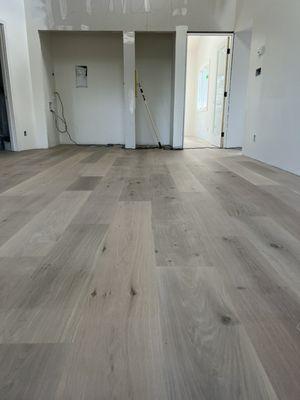 9 1/2" European White Oak.  Sand on site and finished with a light white wash and Bona Traffic HD.