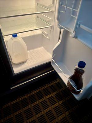 Mini fridge with leftover food from previous a customer.