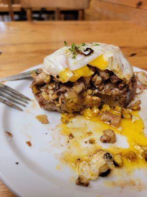 Caramelized mushroom toast with charred corn and fried egg.