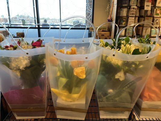 Spring flowers in bags that resemble baskets.