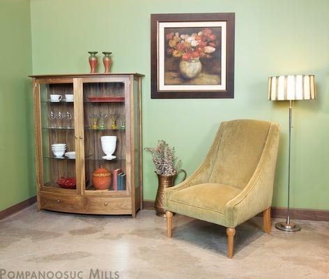 The Strafford Display Cabinet in walnut with the Strafford living room chair.