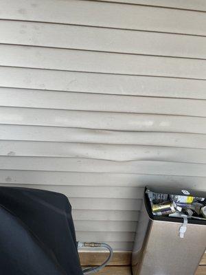 Warped siding from previous owners grill