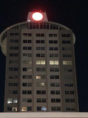 a tall landmark located nearby (red and white iBank logo illuminated on top)