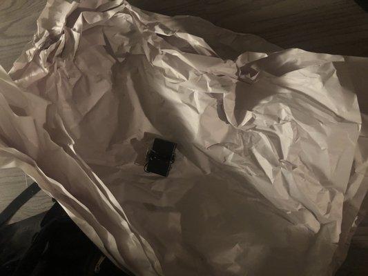 Tiny battery pack wrapped in...what is that....6 sheets of paper.