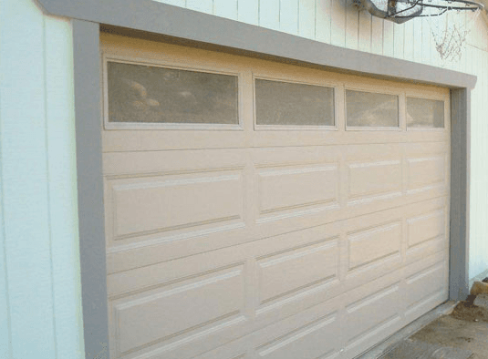 AFTER: The garage door after rewinding the cable and resetting the screws.