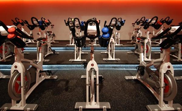 The cycling room that is dimly lit during a class.  The best equipment and weights to work the entire body.