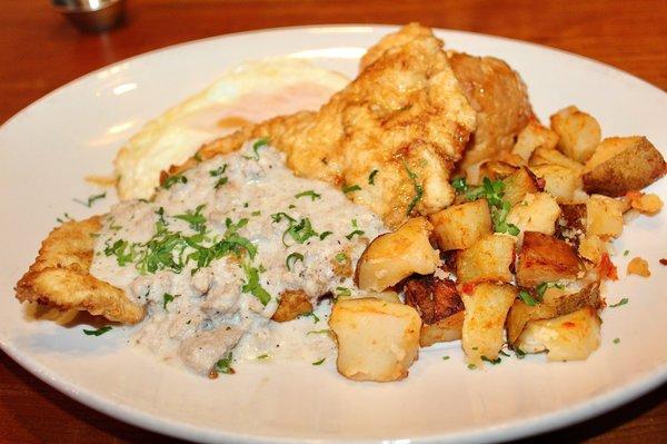 The Brunch Chick was made with buttermilk-battered fried chicken, two eggs, sausage gravy, honey cayenne sauce, biscuit, and potatoes.