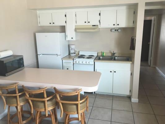 Full kitchen with all the appliances including a 4-burner stove and oven