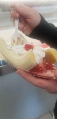 Regular banana split with banana ice cream, strawberry ice cream, whipped cream and cherry.