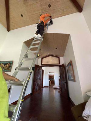 Aslen at a home in Haiku with Ray Catchapiro holding the ladder.