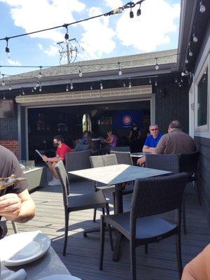 Outdoor patio area. Includes a big-ass TV in the back playing the Cubs game! Really cool spot.