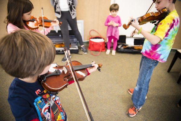 Suzuki Violin for ages 3 and up features private lessons, plus group classes and regular recitals!