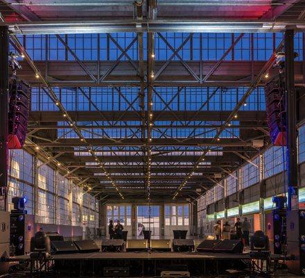 The Bridge Yard's stage, sound system, and indoor space at night