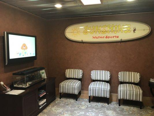 Kids waiting room complimented with hermit crabs, cartoons and books.