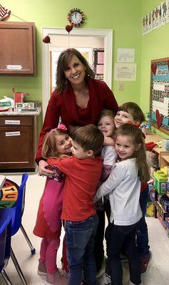 Our Day School Director, Caroline Gore, loves class hugs!