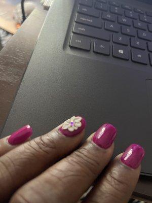 Dip powder nails and a handmade flower design.