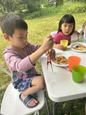 I'm using chopsticks to eat my Chinese lunch. Summer Creative Cooking Camp is so fun!