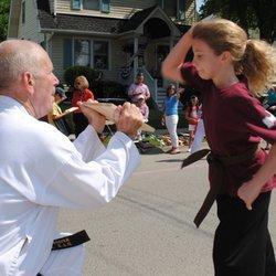 Ainsley a ROCKSTAR Black Belt having FUN breaking board.