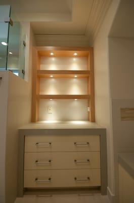 LED pucks illuminating shelving.