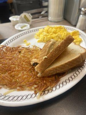 Hashbrowns, scrambled eggs with cheese, toast and grits