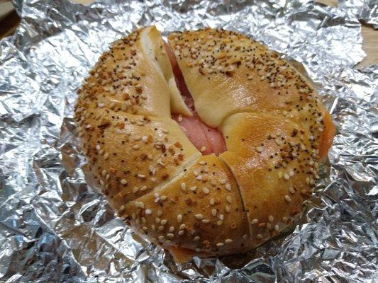 Scooped out everything bagel with scallion cream cheese and lox