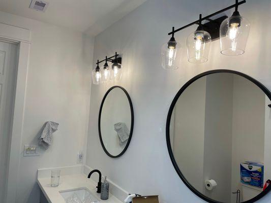 Painted restroom walls, installed new mirrors and vanity lights