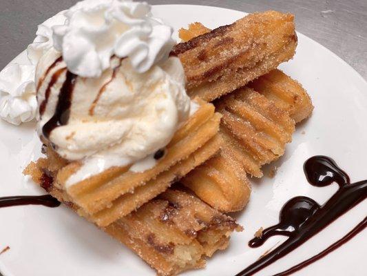 Stuffed cinnamon churros topped with vanilla ice cream