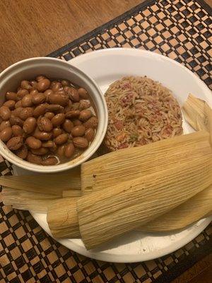 Chicken tamales served with rice and beans