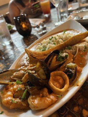 Seafood curry with pineapple rice and lots of seafood. It's a big dish served in a big bowl