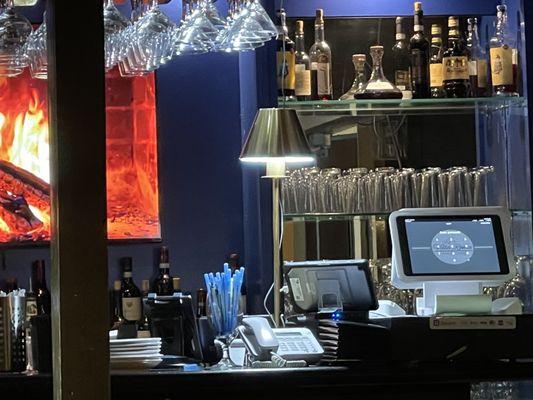 View of the bar area over my left shoulder. I like that color contrast of the dark blue paint with a rich colored fire video.