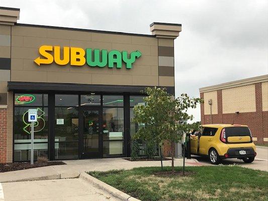 The front of this Subway. Drive-thru seen on the right.