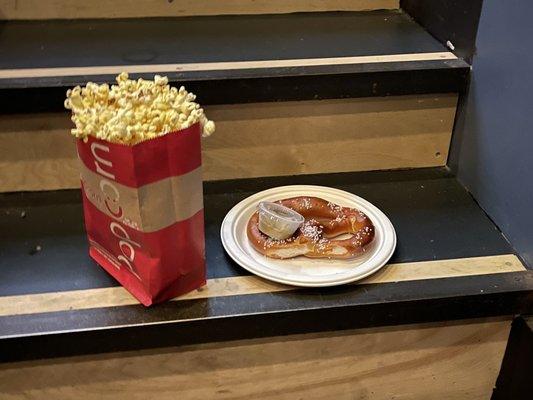 Popcorn and a pretzel with spicy mustard dip