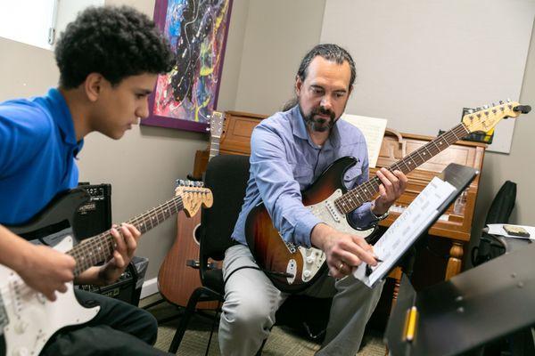 A CMS student in a private guitar lesson.