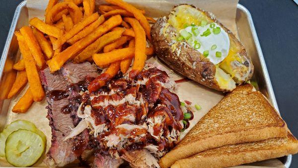 Two meat meal, pulled pork and brisket, with sweet potato fries and loaded baked potato