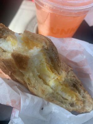 Egg and cheese croissant sandwich and peach drink