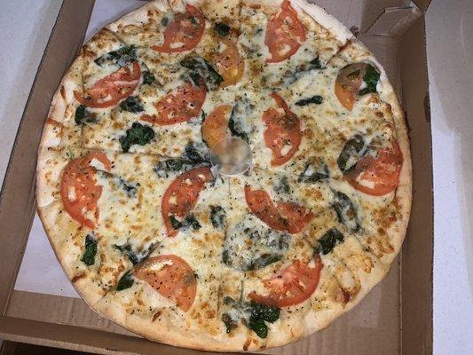 Medium garlic spinach and tomato pizza