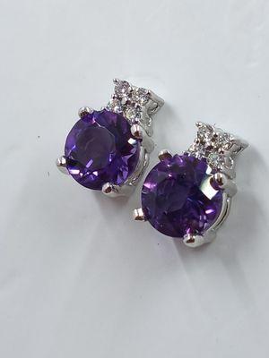 Amethyst and diamond earrings in 14k white gold .