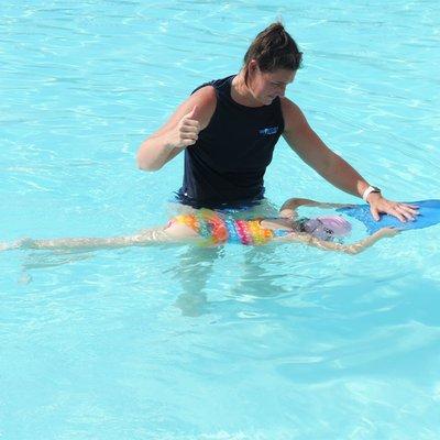 Instructor Rachael teaching a private swim lesson at our summer pool in Spring Hill, TN.