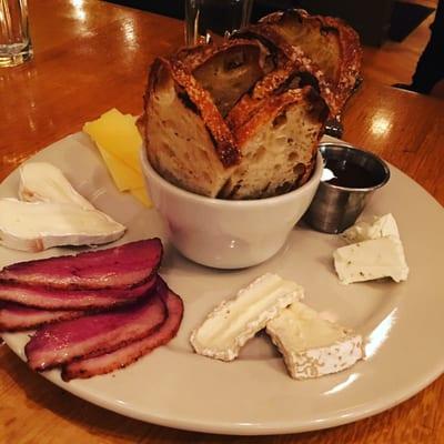 Local cheese board with grilled bread smoked duck and local honey