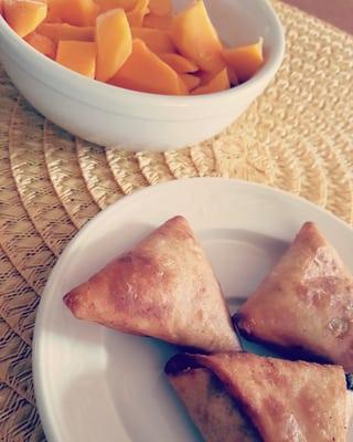 Homemade samosas and freshly cut mangoes