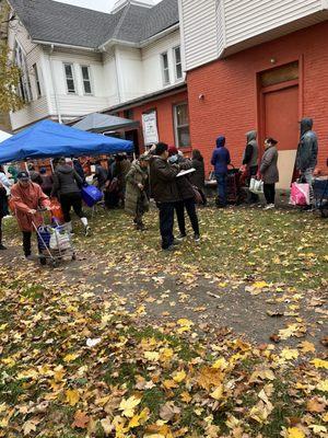 Monthly distribution of free groceries for the community shared by two churches.