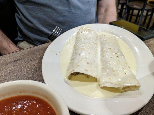 2 beef burritos covered in queso