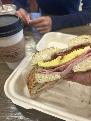 Breakfast sandwich (everything bagel w/ ham, bacon) and almond milk latte