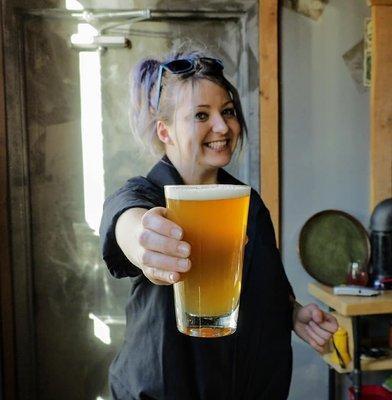 Our head brewer, Erin, offering up a cold one!