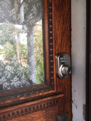 A keypad deadbolt that needed some fitting with a chisel to sit properly by the light (window) in the door.