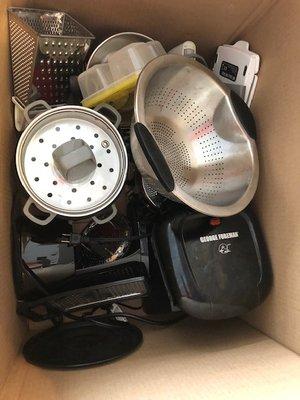 Appliances and kitchen gadgets tossed in a box