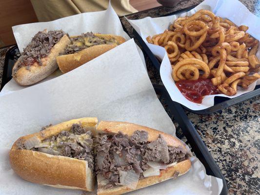 Philly cheesesteak, chopped cheesesteak, and large curly fries